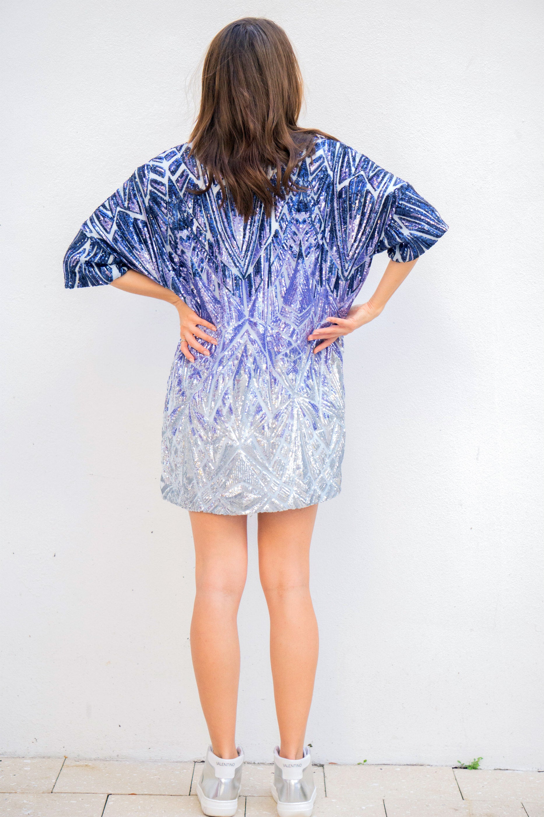 Instant sophistication day or night with a top that's as versatile as it is flattering. Inspired by her evening gown collection, Donna Leah has launched this new collection of five oversized tops that are all about shine, color, and confidence.  The Sizzle Series is a collection of a variety of colors and hues of sparkles, each Sizzle is a different shine no 2 alike.